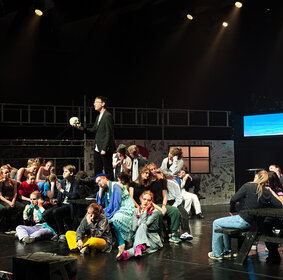 Schülerinnen und Schüler performen auf der Bühne